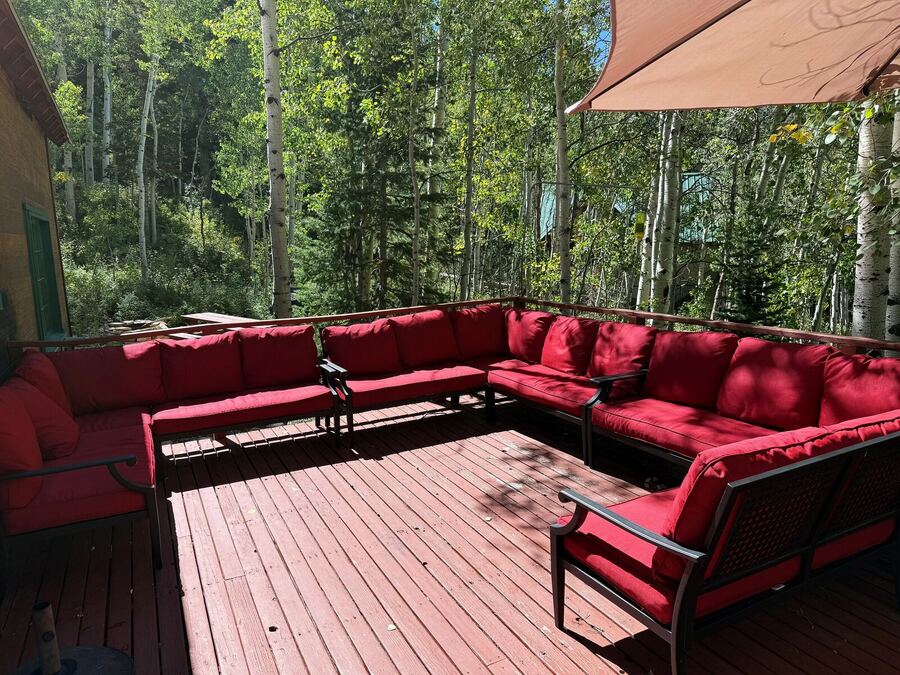 A large red cushioned sectional lounge wrapping around the deck